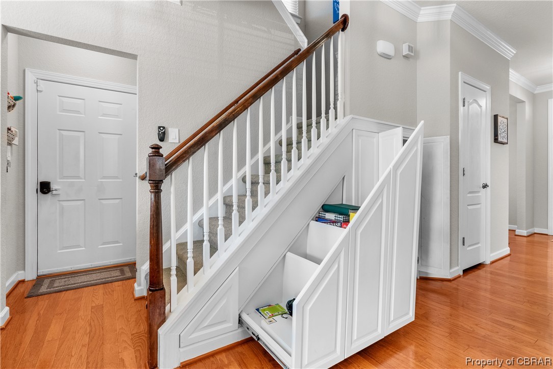 2124 Piedmont Road Suffolk, VA 23435 - Photo 9 of 41 Staircase with crown molding and light hardwood / wood-style flooring
