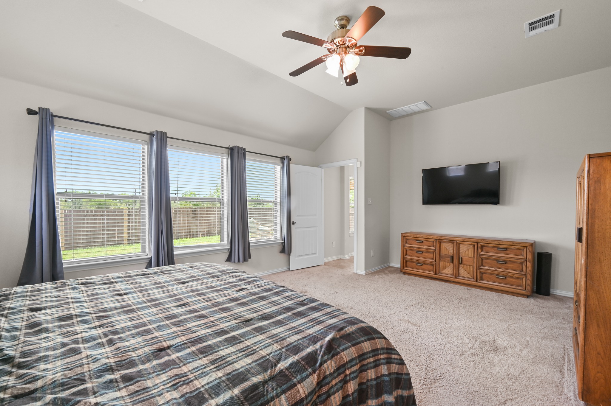 877 Hot Spring Valley Buda, TX 78610 - Photo 18 of 36 a bedroom with a bed and a flat screen tv
