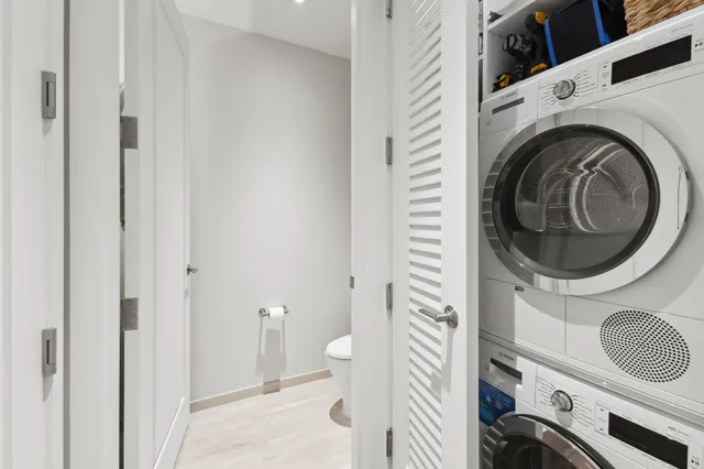 a view of a bathroom with washing machine and sink