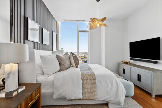 a bedroom with a bed and a flat screen tv
