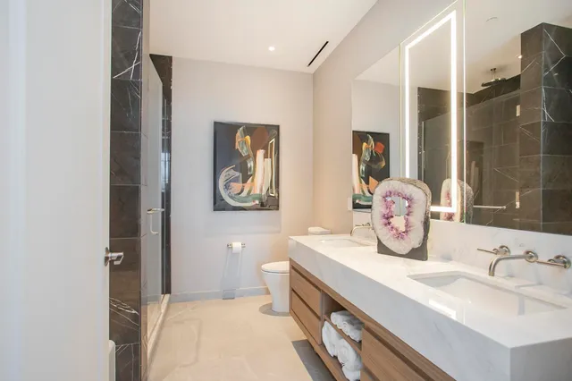 a bathroom with a sink double vanity and a shower