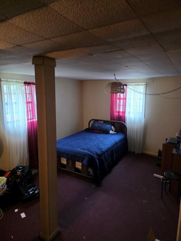 1882 Glen Echo Drive Decatur, GA 30032 - Photo 20 of 24 a spacious bedroom with a bed and a chandelier