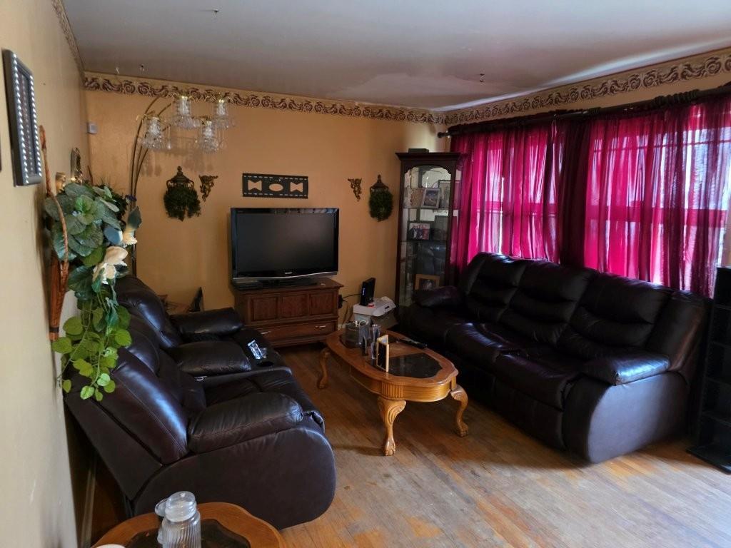 1882 Glen Echo Drive Decatur, GA 30032 - Photo 5 of 24 a living room with furniture a flat screen tv and a window