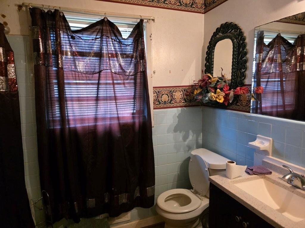 1882 Glen Echo Drive Decatur, GA 30032 - Photo 10 of 24 a bathroom with a toilet sink and mirror