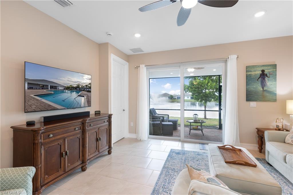 846 Enbrook Loop Naples, FL 34114 - Photo 2 of 45 a living room with furniture and a flat screen tv