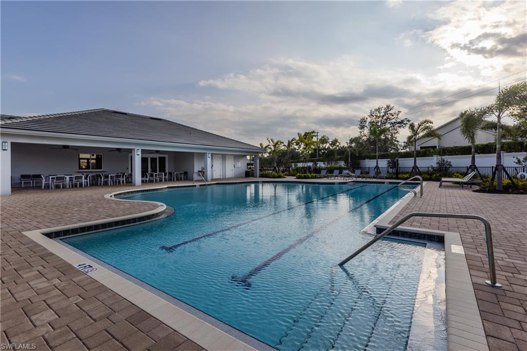 846 Enbrook Loop Naples, FL 34114 - Photo 23 of 45 a view of a patio with couches chairs and a table and chairs with wooden floor