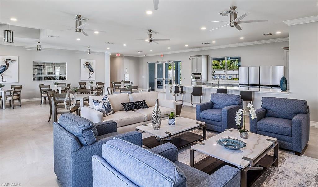 846 Enbrook Loop Naples, FL 34114 - Photo 27 of 45 a living room with furniture kitchen view and a table