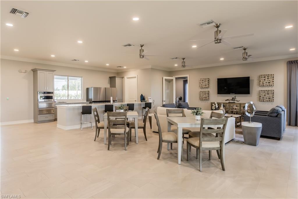 846 Enbrook Loop Naples, FL 34114 - Photo 28 of 45 a large kitchen with a table and chairs