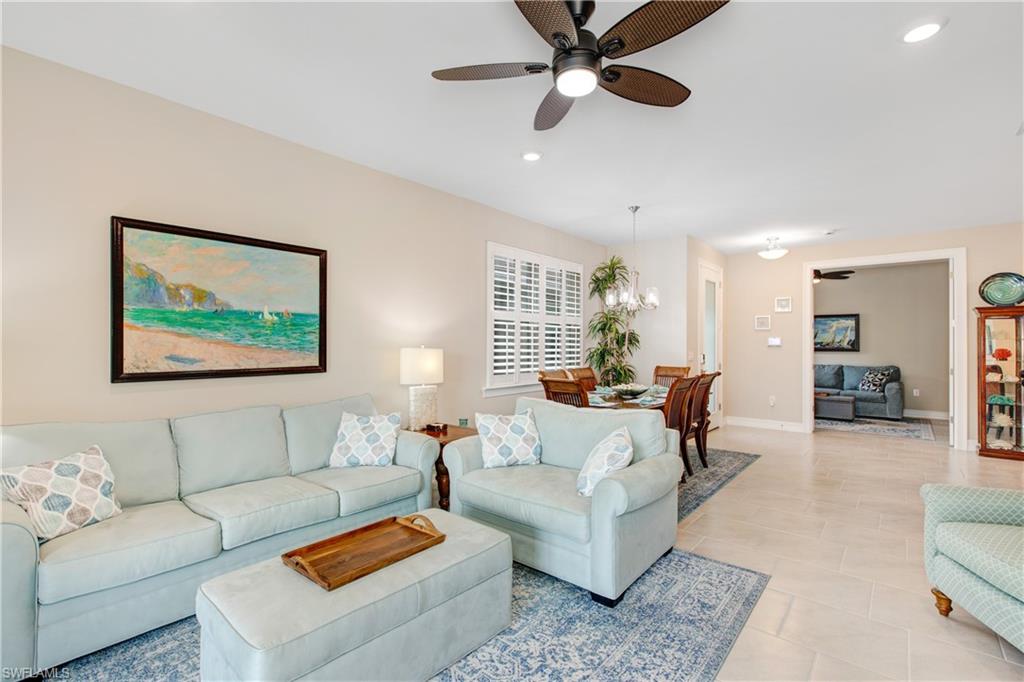 846 Enbrook Loop Naples, FL 34114 - Photo 3 of 45 a living room with furniture and a large window
