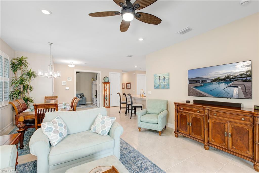 846 Enbrook Loop Naples, FL 34114 - Photo 4 of 45 a living room with furniture and a flat screen tv