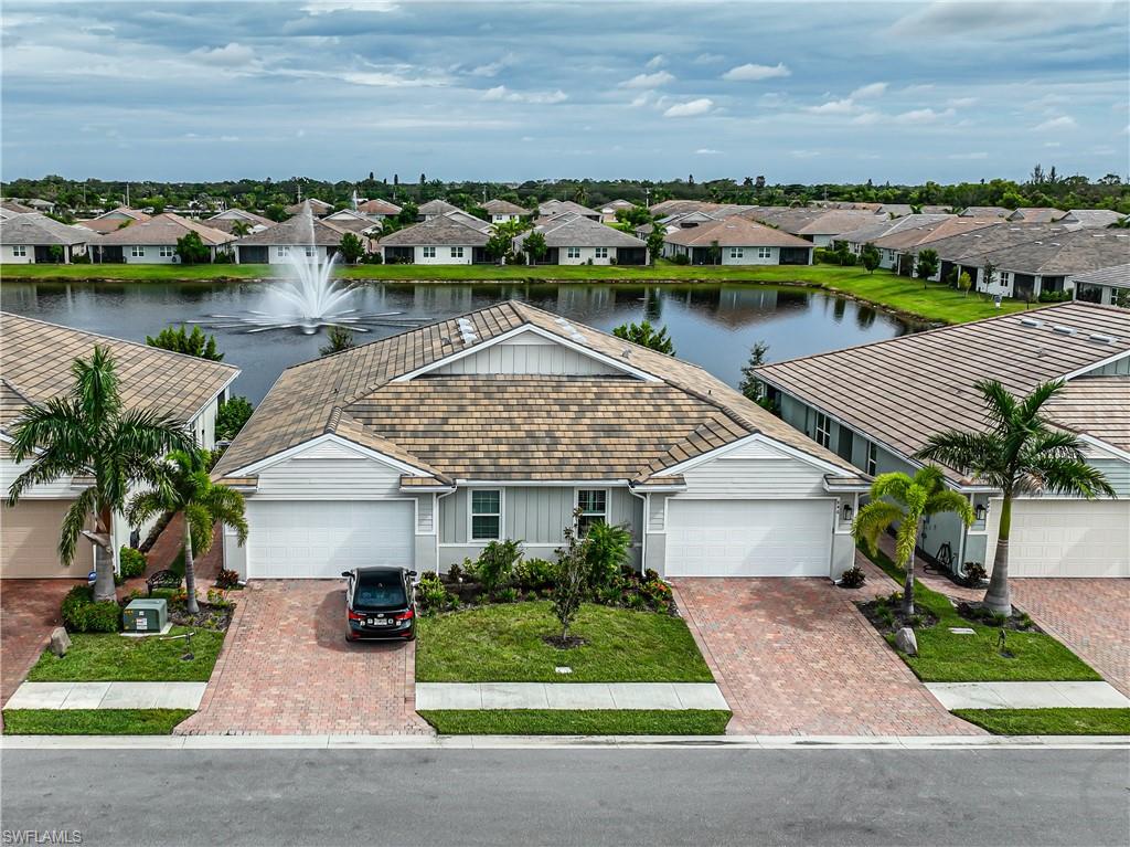 846 Enbrook Loop Naples, FL 34114 - Photo 44 of 45 a front view of a house with garden