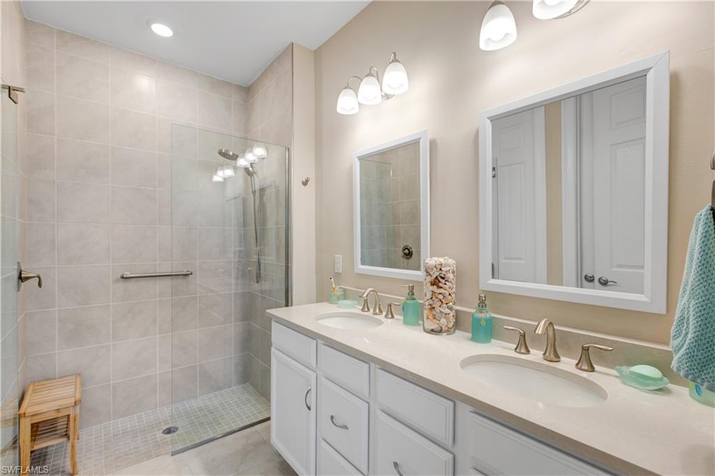 846 Enbrook Loop Naples, FL 34114 - Photo 10 of 45 a bathroom with double sink and a mirror
