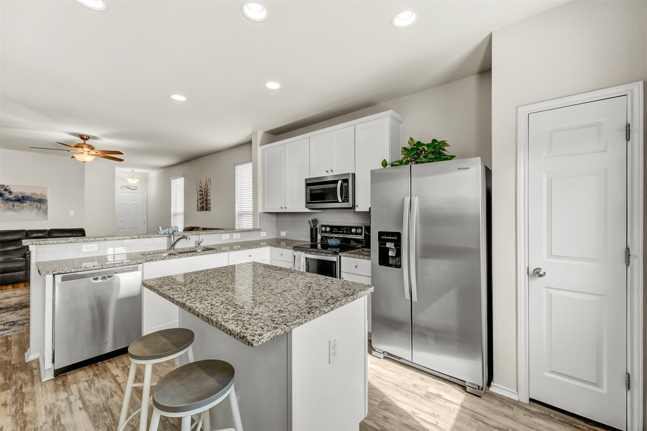 213 Ibis Falls Loop Jarrell, TX 76537 - Photo 11 of 37 A well-appointed kitchen features stainless steel appliances, granite countertops, and an inviting island with casual seating.