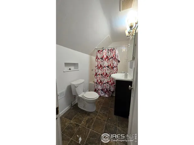 a black and white building with trees in the background