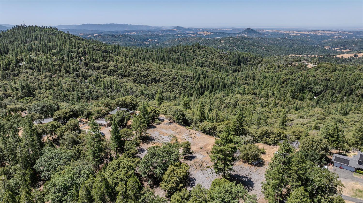 20117 Neilson Road Pine Grove, CA 95665 - Photo 28 of 32 a view of a lush green field with mountains in the background