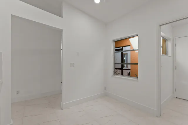 an empty room with windows and closet