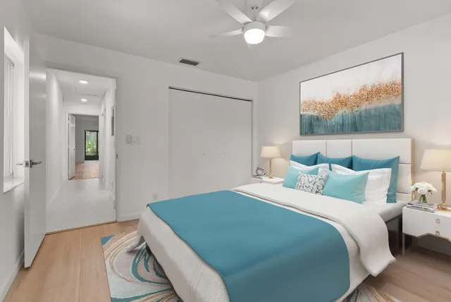 a bedroom with a bed and a painting on the wall