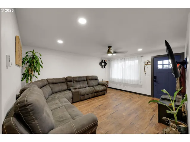 a living room with furniture and a potted plant