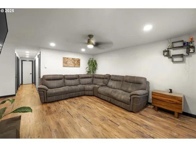 a living room with furniture and a wooden floor