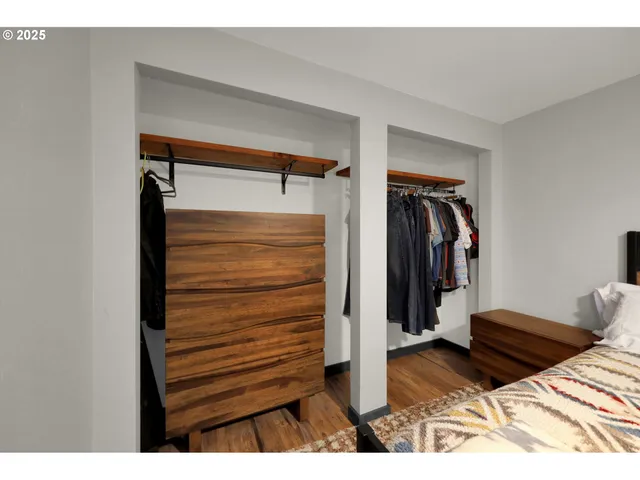 a view of walk in closet with clothes and shoes