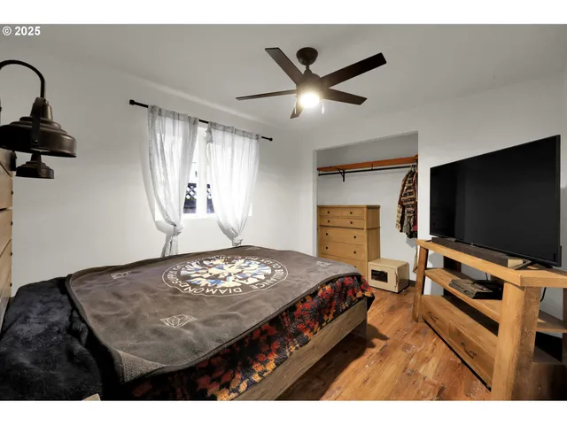 a bedroom with a bed and a flat screen tv