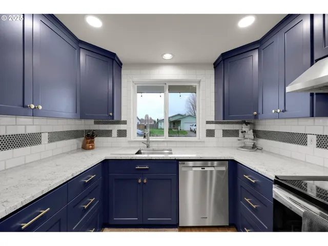 a kitchen with a sink a window and appliances