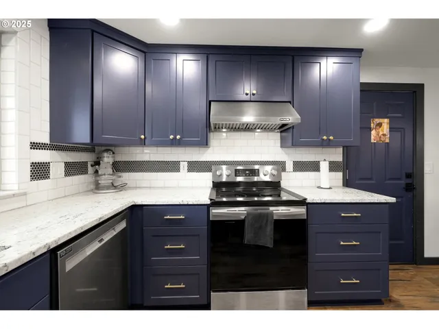 a kitchen with a sink a stove and cabinets