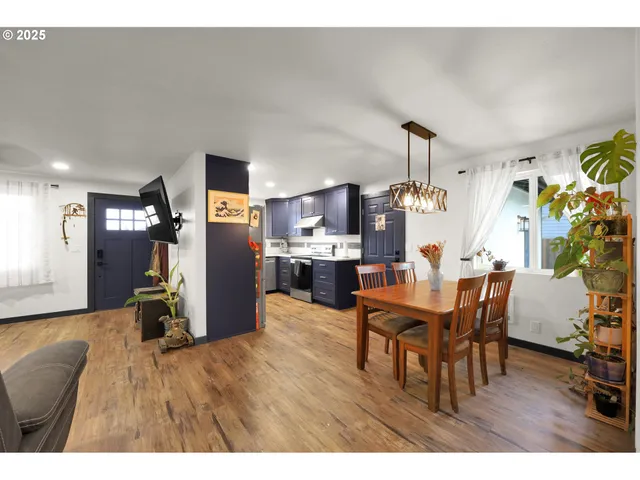 a dining room with furniture and wooden floor