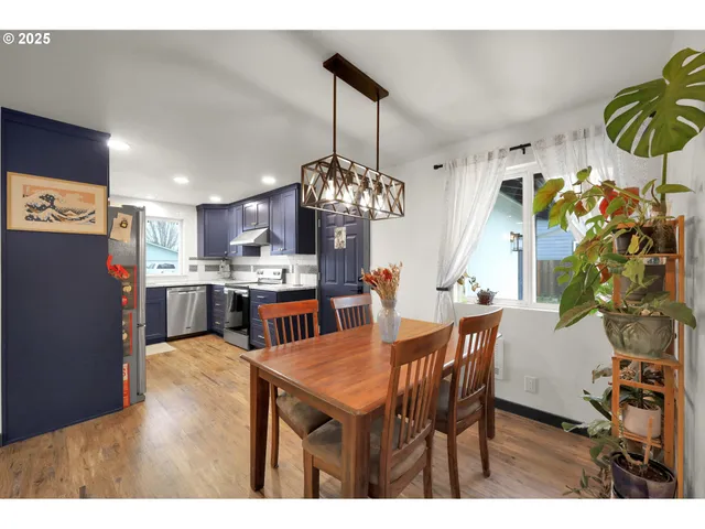 a view of a dining room with furniture and chandelier