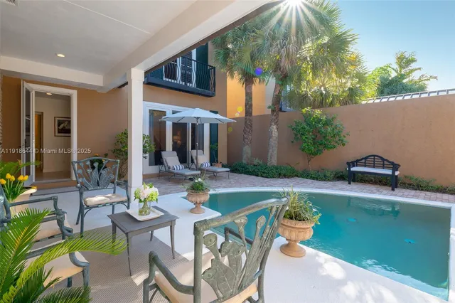 a view of a patio with table and chairs and potted plants