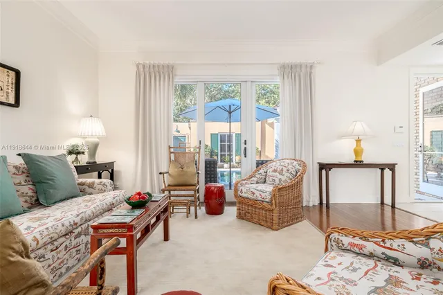 a bedroom with furniture and a large window