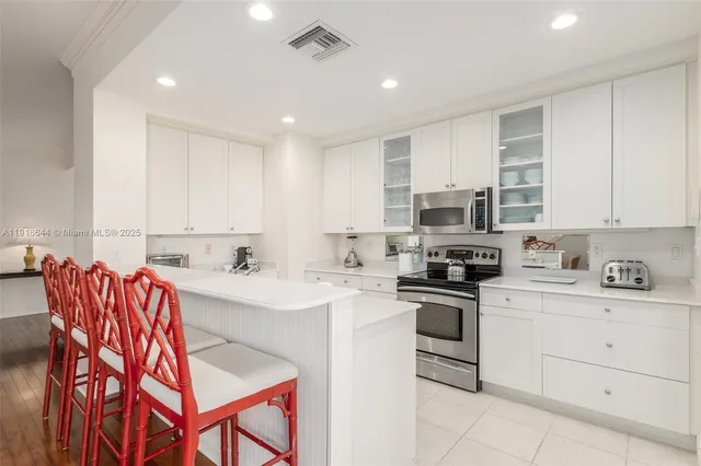 a kitchen with stainless steel appliances granite countertop a sink and cabinets