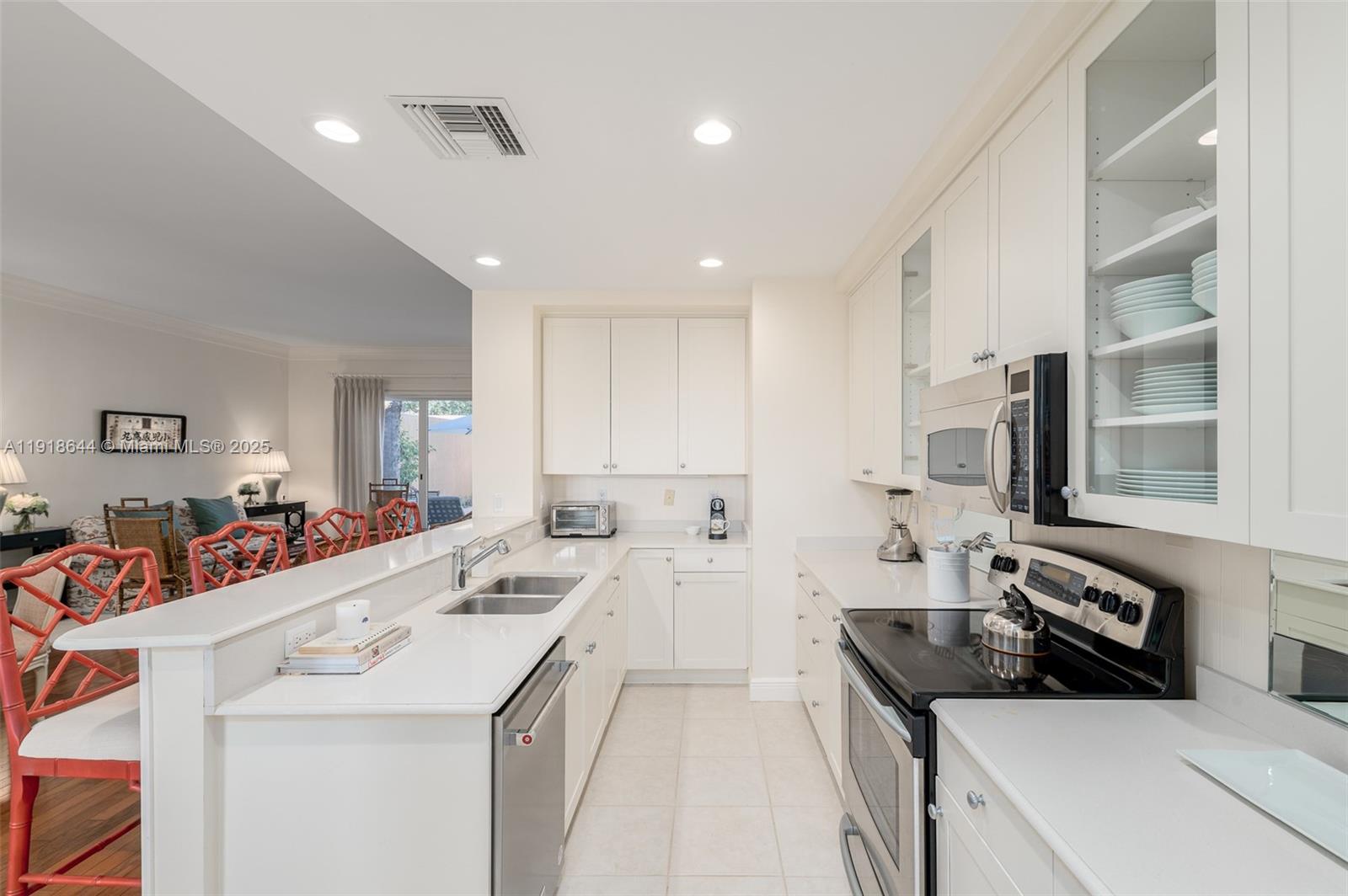 11609 Southeast Florida Avenue Hobe Sound, FL 33455 - Photo 17 of 31 a kitchen that has a sink and a stove in it