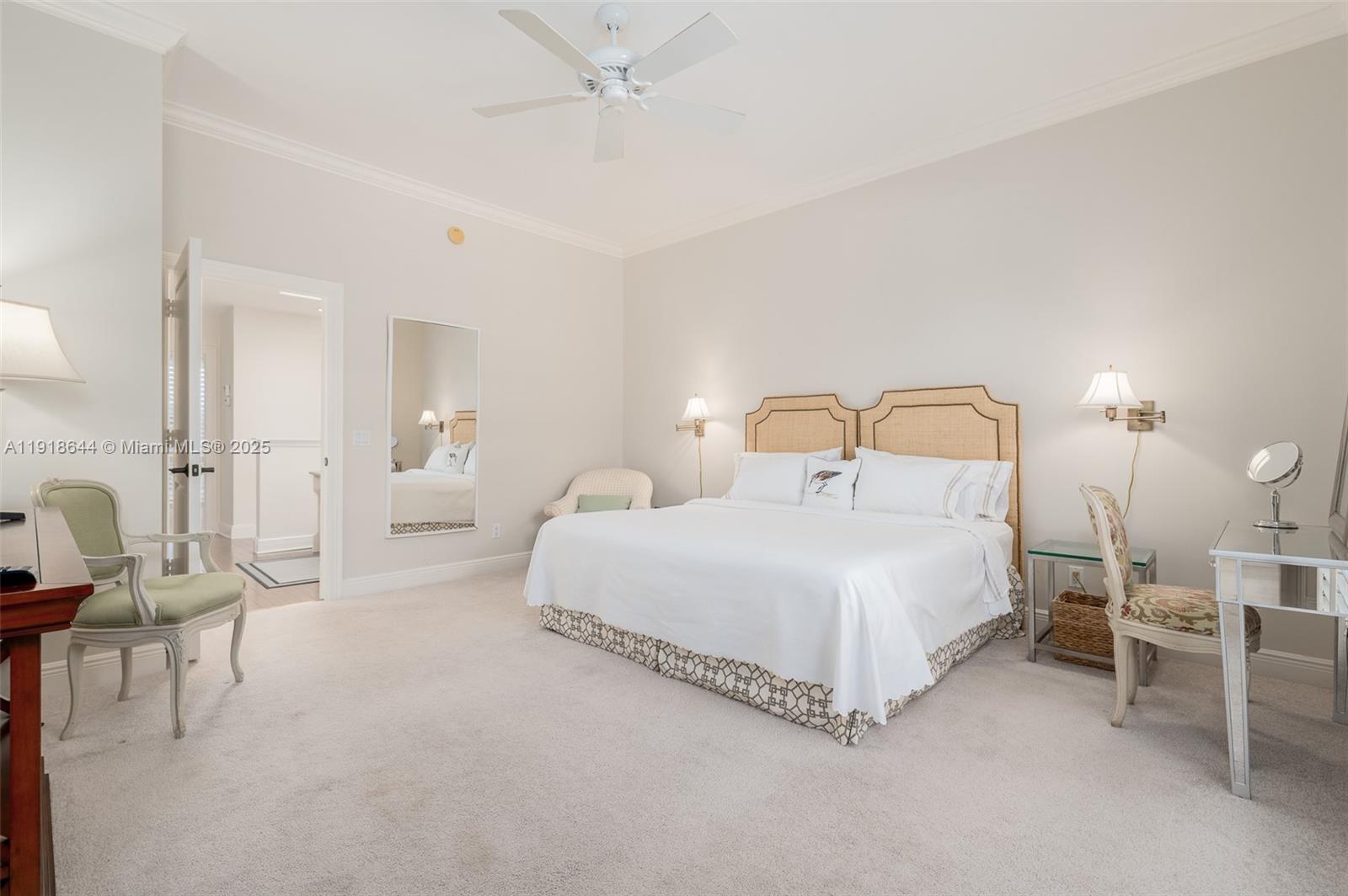 11609 Southeast Florida Avenue Hobe Sound, FL 33455 - Photo 22 of 31 a bedroom with a bed and a chandelier