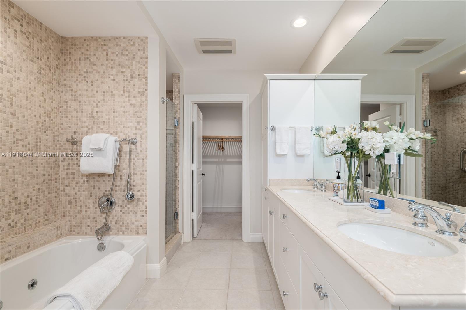 11609 Southeast Florida Avenue Hobe Sound, FL 33455 - Photo 23 of 31 a bathroom with a bathtub sink and mirror