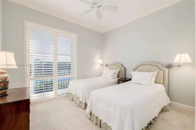 a bedroom with two beds and a chandelier
