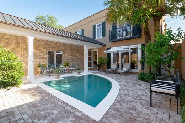 a view of a house with backyard porch and sitting area