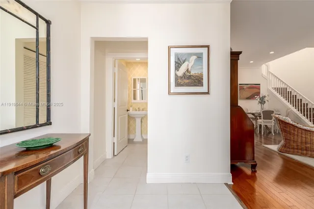 a hallway with a sink and a refrigerator