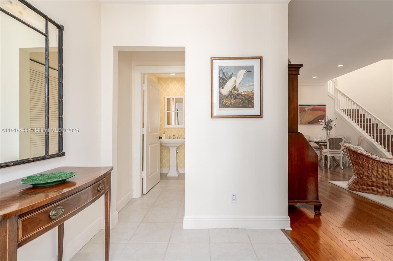 11609 Southeast Florida Avenue Hobe Sound, FL 33455 - Photo 8 of 31 a hallway with a sink and a refrigerator