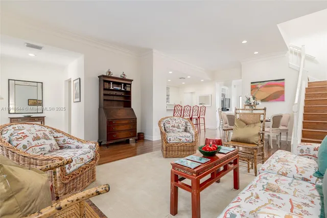 a living room with furniture and a dresser