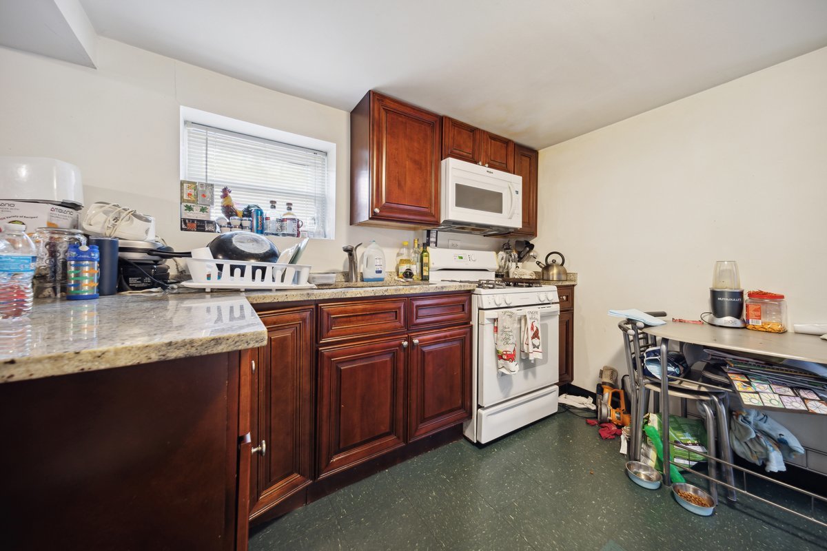 4703 West Parker Avenue Chicago, IL 60639 - Photo 17 of 27 a kitchen with a sink stove and cabinets