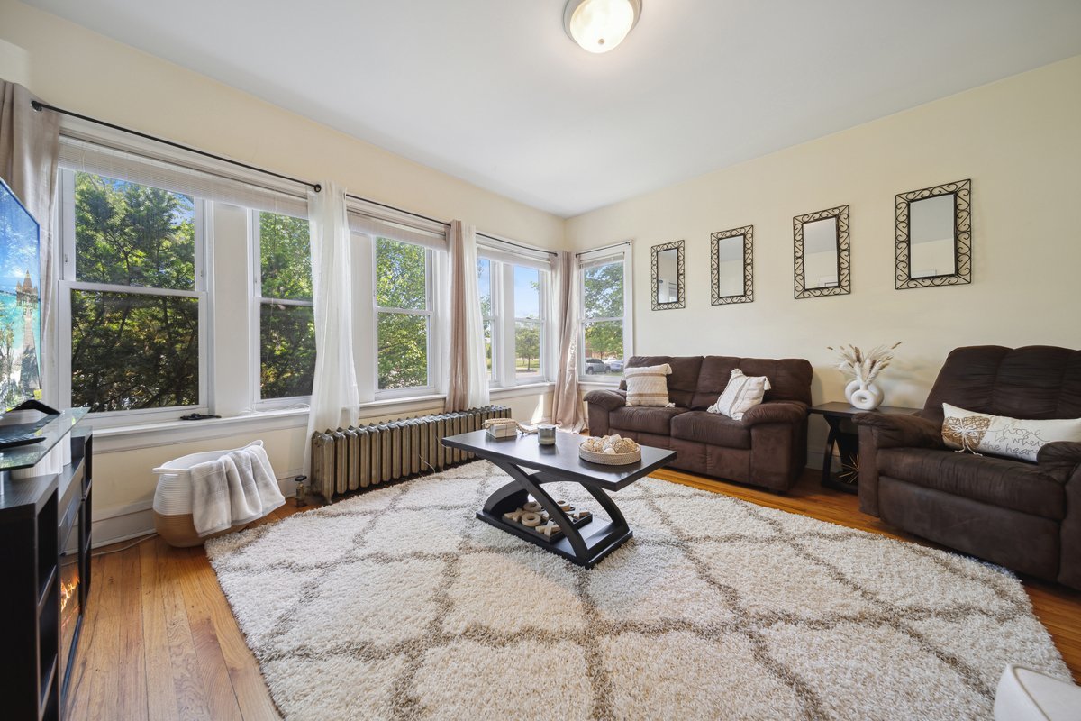 4703 West Parker Avenue Chicago, IL 60639 - Photo 2 of 27 a living room with furniture large windows and wooden floor