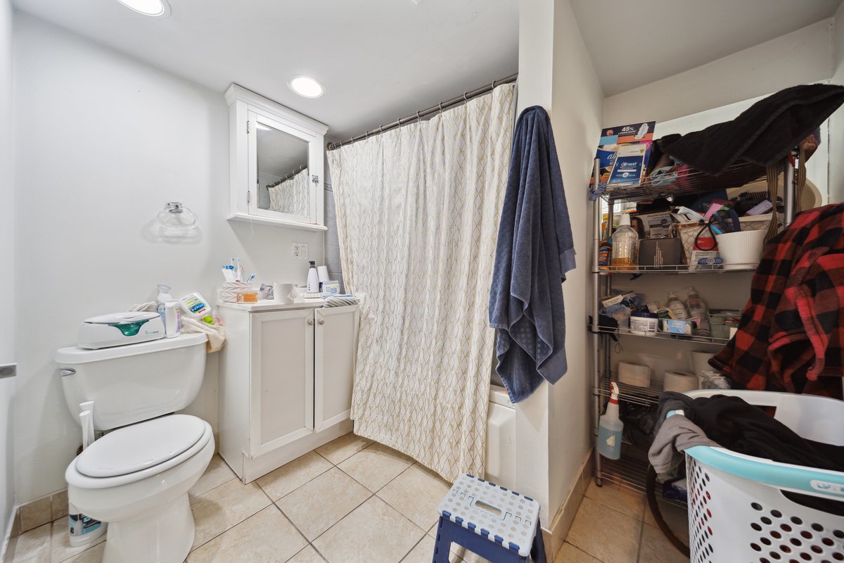 4703 West Parker Avenue Chicago, IL 60639 - Photo 21 of 27 a view of walk in closet with clothes and shoes