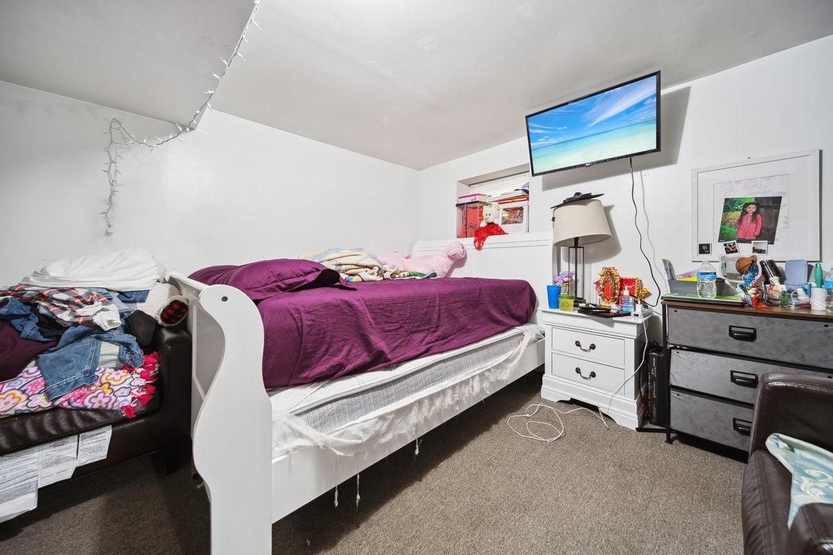 4703 West Parker Avenue Chicago, IL 60639 - Photo 23 of 27 a bed room with a bed and a baby crib