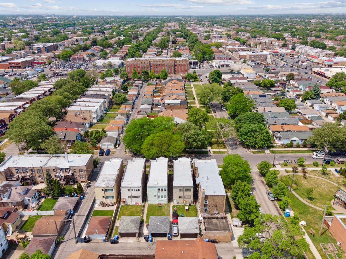 4703 West Parker Avenue Chicago, IL 60639 - Photo 25 of 27 an aerial view of residential houses with outdoor space and parking