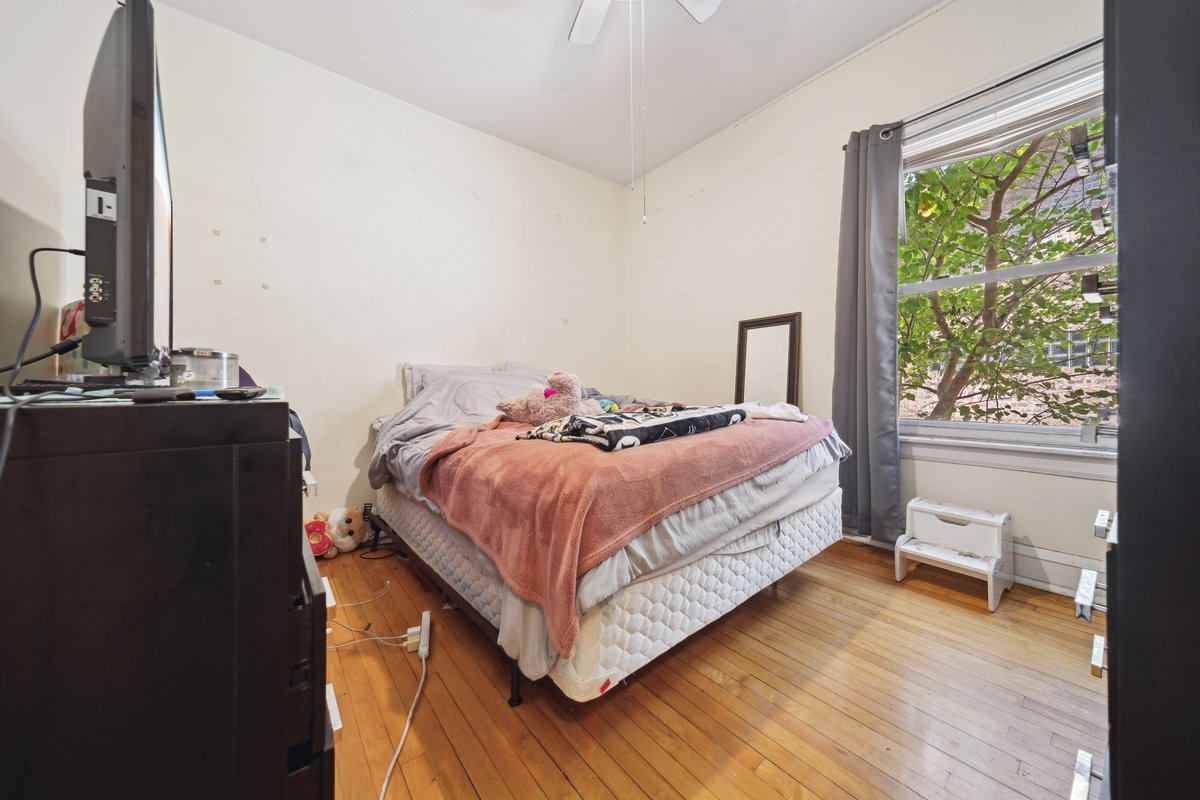 4703 West Parker Avenue Chicago, IL 60639 - Photo 7 of 27 a bedroom with a bed and a window