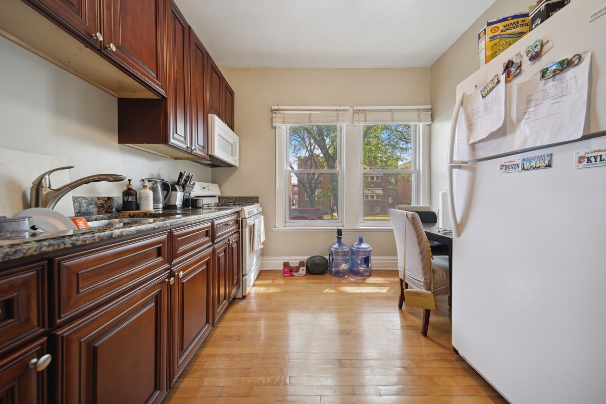 4703 West Parker Avenue Chicago, IL 60639 - Photo 8 of 27 a kitchen with stainless steel appliances a sink a stove and a refrigerator