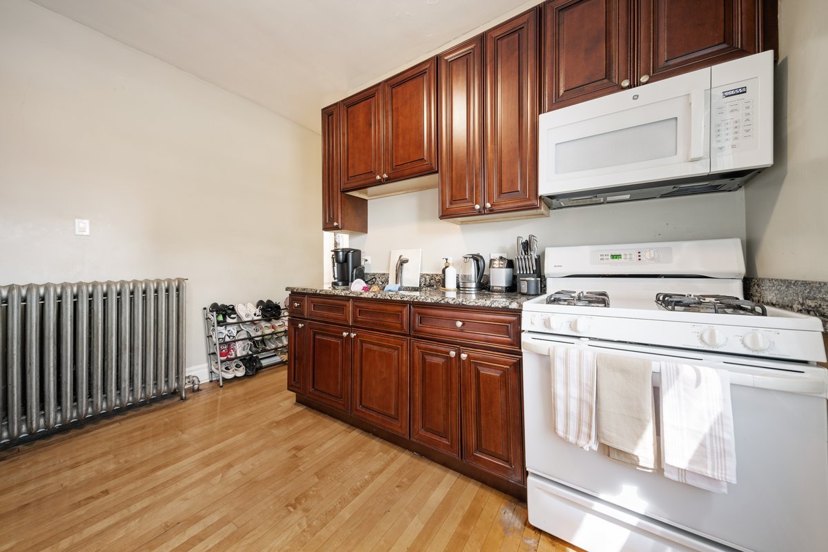 4703 West Parker Avenue Chicago, IL 60639 - Photo 9 of 27 a kitchen with stainless steel appliances granite countertop a sink stove and cabinets