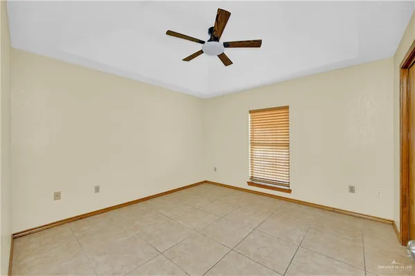 a view of room with ceiling fan and window
