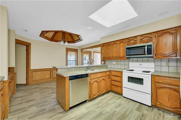 a kitchen with stainless steel appliances granite countertop a stove and a sink